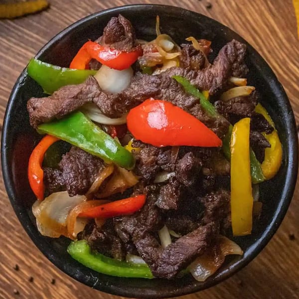 Rohobot Ethiopian Restaurant's tibs, featuring beef, red, green, and yellow bell peppers, and onions.